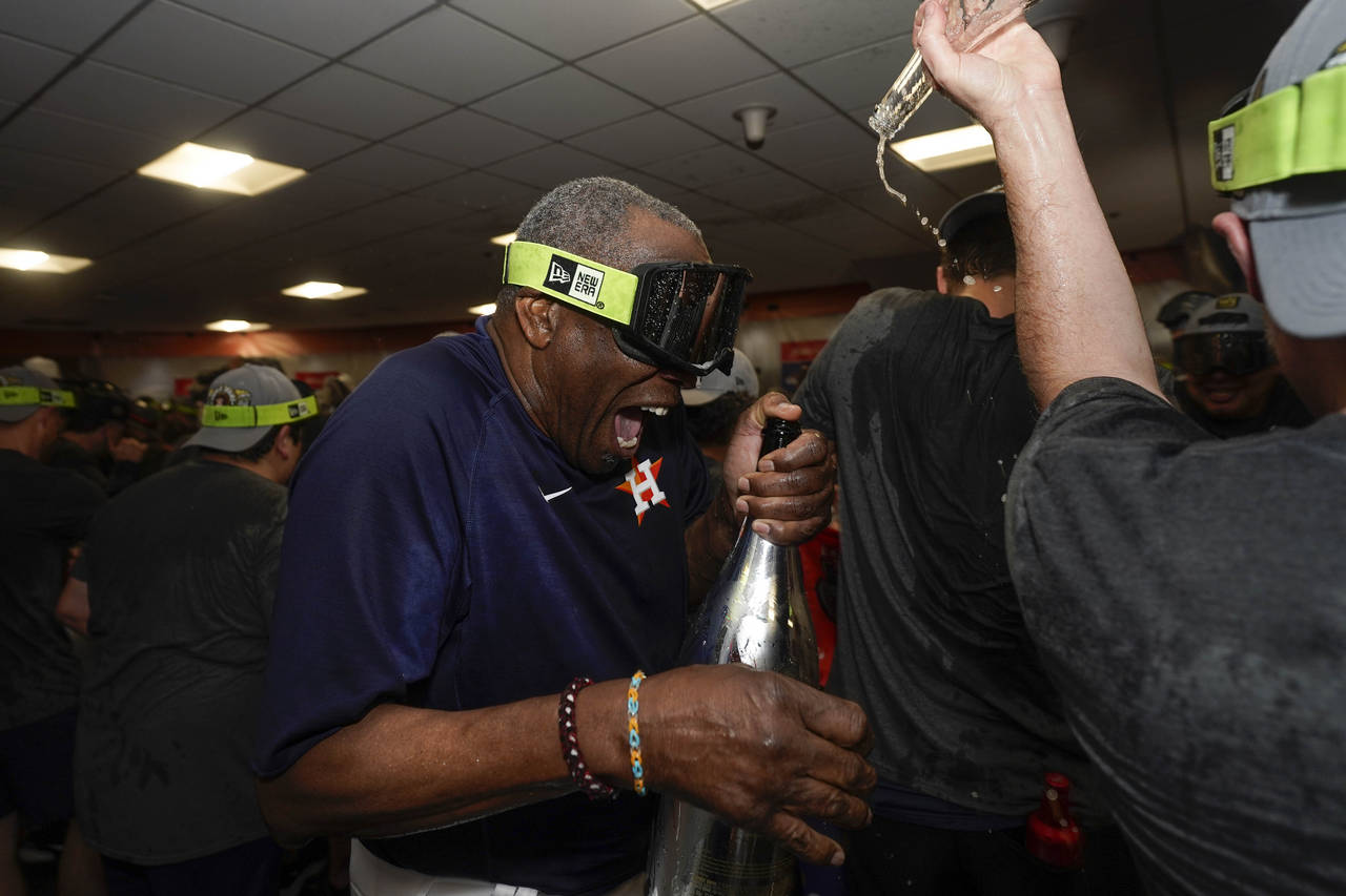 Houston Astros manager Dusty Baker Jr. celebrates in the locker room after their 4-1 World Series w...