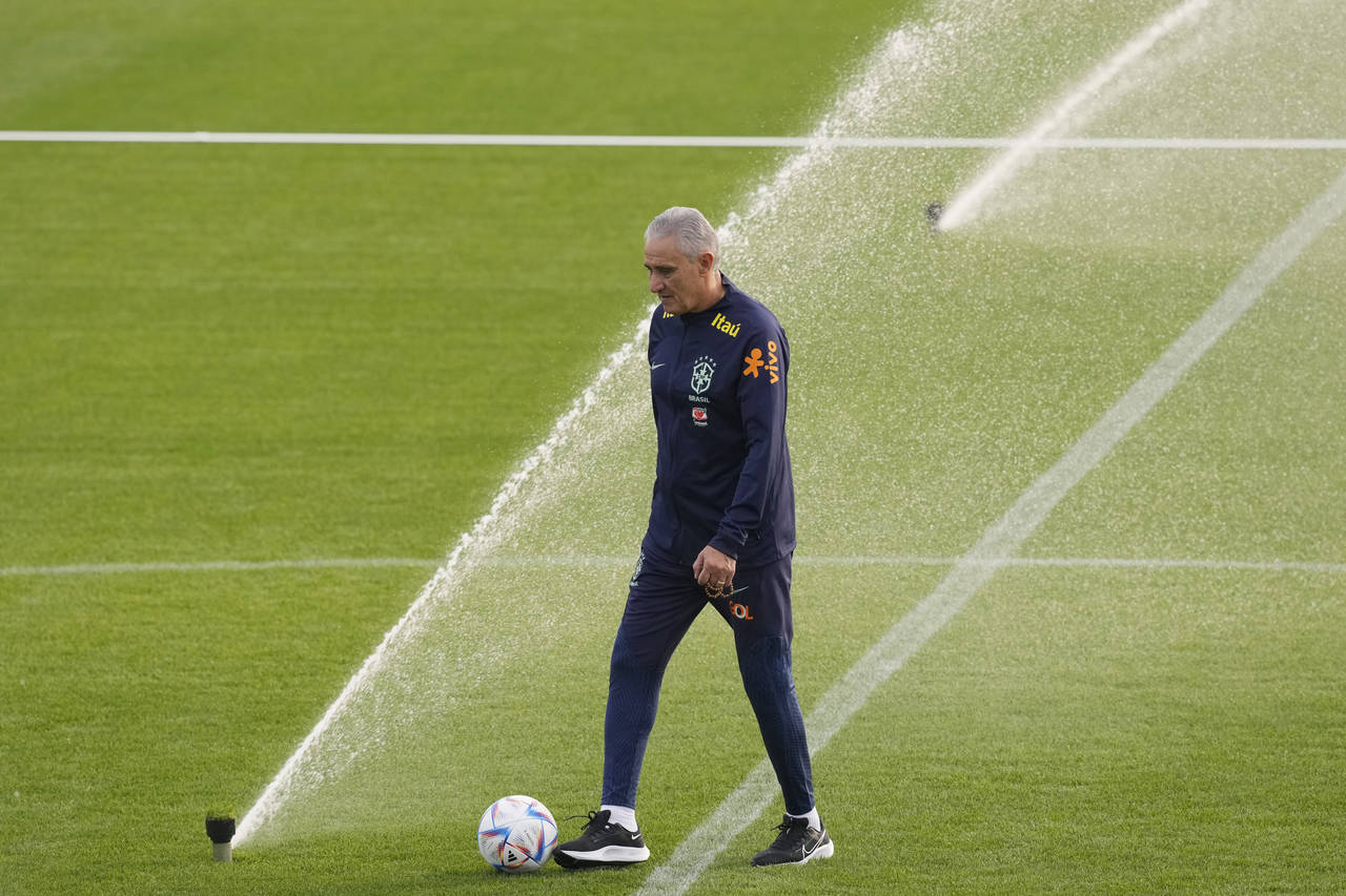 Brazil's coach Tite walks during a training session at the Continassa sporting center, in Turin, It...