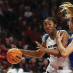 
              South Carolina forward Aliyah Boston, left, drives into UCLA forward Emily Bessoir during the second half of an NCAA college basketball game in Columbia, S.C., Tuesday, Nov. 29, 2022. South Carolina won 73-64. (AP Photo/Nell Redmond)
            