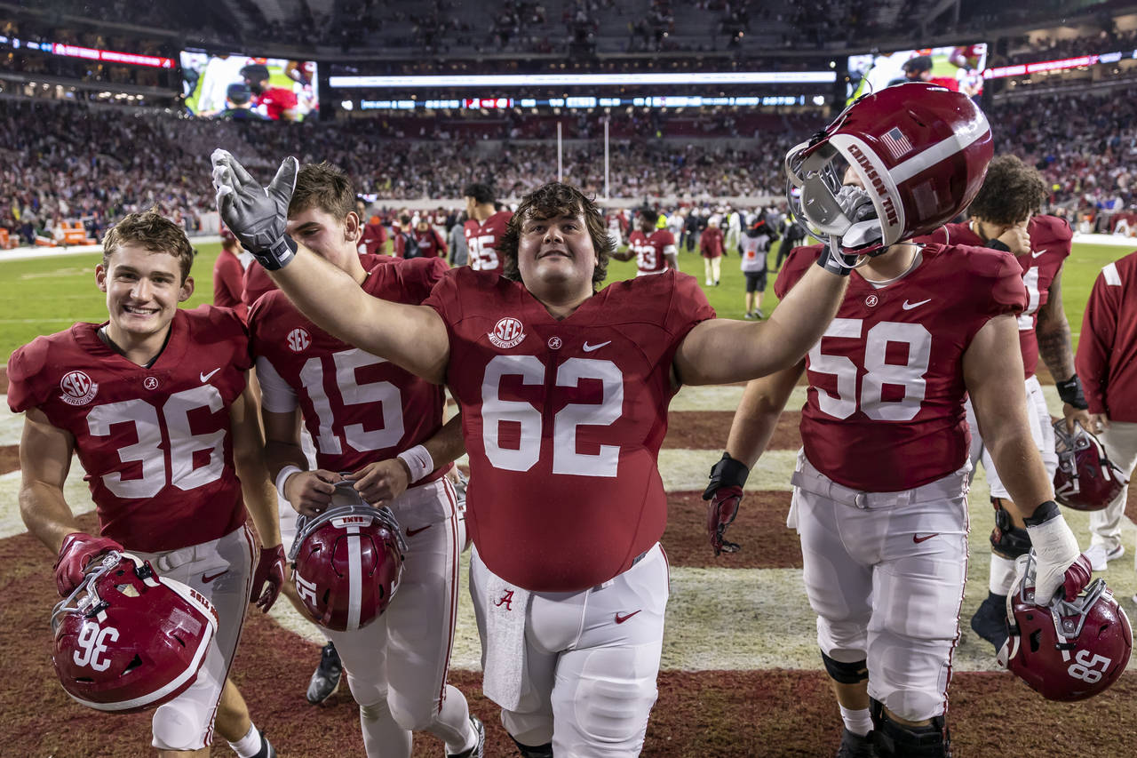 Alabama offensive lineman Jackson Roby (62) salutes the fans as he and his teammates depart the fie...