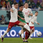 
              Poland's Robert Lewandowski, Mexico's Edson Alvarez and Poland's Piotr Zielinski, from left, challenge for the ball during the World Cup group C soccer match between Mexico and Poland, at the Stadium 974 in Doha, Qatar, Tuesday, Nov. 22, 2022. (AP Photo/Martin Meissner)
            