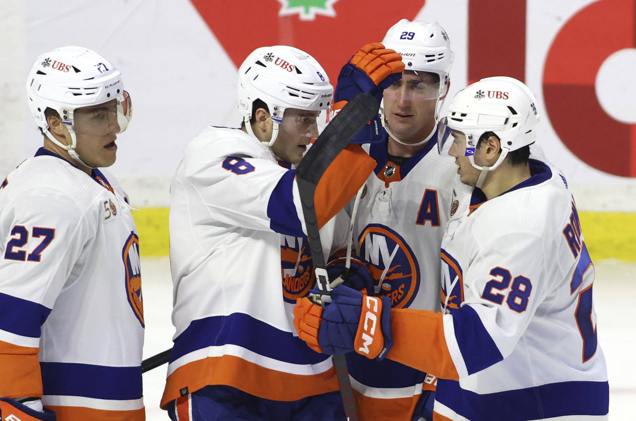 New York Islanders defenseman Noah Dobson (8) celebrates his goal with teammates Anders Lee (27), B...