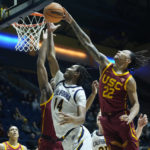 
              Southern California guard Tre White (22) blocks a shot by California forward Grant Newell (14) during the first half of an NCAA college basketball game in Berkeley, Calif., Wednesday, Nov. 30, 2022. (AP Photo/Godofredo A. Vásquez)
            