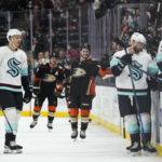 
              Anaheim Ducks' Mason McTavish, center, smiles after his goal during the second period of the team's NHL hockey game against the Seattle Kraken on Sunday, Nov. 27, 2022, in Anaheim, Calif. (AP Photo/Jae C. Hong)
            