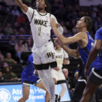 
              Wake Forest's Tyree Appleby sinks a lay up under pressure from Hampton's Daniel Banister during an NCAA college basketball game, Saturday, Nov. 26, 2022,  at Joel Coliseum in Winston-Salem, N.C. (Walt Unks/The Winston-Salem Journal via AP)
            