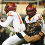 
              Iowa State offensive lineman Darrell Simmons Jr. (55) watches as Oklahoma State defensive end Nathan Latu (92) sacks Iowa State quarterback Hunter Dekkers (12) during the final minutes of an NCAA college football game Saturday, Nov. 12, 2022, in Stillwater, Okla. (AP Photo/Brody Schmidt)
            