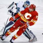 
              Seattle Kraken goalie Joey Daccord, left, comes out the crease to play the puck as Calgary Flames forward Tyler Toffoli crashes into him during the third period of an NHL hockey game, Tuesday, Nov. 1, 2022 in Calgary, Alberta. (Jeff McIntosh/The Canadian Press via AP)
            