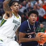
              Virginia guard Reece Beekman (2) drives to the basket against Baylor forward Jalen Bridges (11) during the first half of an NCAA college basketball game Friday, Nov. 18, 2022, in Las Vegas. (AP Photo/Chase Stevens)
            