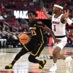 
              Appalachian State guard Terence Harcum (23) drives around Louisville guard El Ellis (3) during the first half of an NCAA college basketball game in Louisville, Ky., Tuesday, Nov. 15, 2022. (AP Photo/Timothy D. Easley)
            