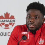 
              Canada forward Alphonso Davies speaks to the media after practice at the World Cup soccer tournament in Doha, Qatar on Tuesday, Nov. 29, 2022. (Nathan Denette/The Canadian Press via AP)
            