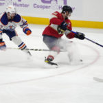 
              Edmonton Oilers defenseman Brett Kulak (27) and Florida Panthers center Aleksander Barkov, right, go for the puck during the third period of an NHL hockey game, Saturday, Nov. 12, 2022, in Sunrise, Fla. (AP Photo/Lynne Sladky)
            