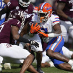 
              Florida running back Trevor Etienne (7) gets past Texas A&M defensive back Tyreek Chappell (7) during a run in the first quarter of an NCAA college football game Saturday, Nov. 5, 2022, in College Station, Texas. (AP Photo/Sam Craft)
            
