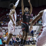 
              Jacksonville State guard Peyton Daniels (13) shoots a 3-point basket over Alabama forward Brandon Miller, left, during the first half of an NCAA college basketball game, Friday, Nov. 18, 2022, in Tuscaloosa, Ala. (AP Photo/Vasha Hunt)
            