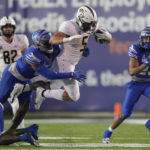 
              Central Florida running back Isaiah Bowser (5) is hit by Memphis linebacker Xavier Cullens in the second half of an NCAA college football game Saturday, Nov. 5, 2022, in Memphis, Tenn. (AP Photo/Mark Humphrey)
            
