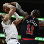
              Denver Nuggets' Aaron Gordon, left, goes up to shoot against Chicago Bulls' DeMar DeRozan (11) during the first half of an NBA basketball game Sunday, Nov. 13, 2022, in Chicago. (AP Photo/Paul Beaty)
            
