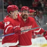 
              Detroit Red Wings' Jonatan Berggren (52) celebrates his goal with Filip Hronek (17) in the first period of an NHL hockey game against the Buffalo Sabres Wednesday, Nov. 30, 2022, in Detroit. (AP Photo/Paul Sancya)
            