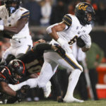 
              California running back Jaydn Ott is brought down by Oregon State linebacker Omar Speights and linebacker Andrew Chatfield Jr. during the first half of an NCAA college football game on Saturday, Nov 12, 2022, in Corvallis, Ore. (AP Photo/Amanda Loman)
            