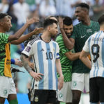 
              Argentina's Lionel Messi standing beside Saudi Arabia's players celebrating after winning the World Cup group C soccer match between Argentina and Saudi Arabia at the Lusail Stadium in Lusail, Qatar, Tuesday, Nov. 22, 2022. (AP Photo/Natacha Pisarenko)
            