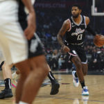 
              Los Angeles Clippers guard Paul George (13) surveys the court during the first half of the team's NBA basketball game against the San Antonio Spurs on Saturday, Nov. 19, 2022, in Los Angeles. (AP Photo/Allison Dinner)
            