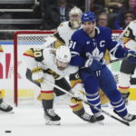 
              Toronto Maple Leafs forward John Tavares (91) and Vegas Golden Knights forward Chandler Stephenson (20) battle for the puck during the first period of an NHL hockey game, Tuesday, Nov. 8, 2022 in Toronto. (Nathan Denette/The Canadian Press via AP)
            