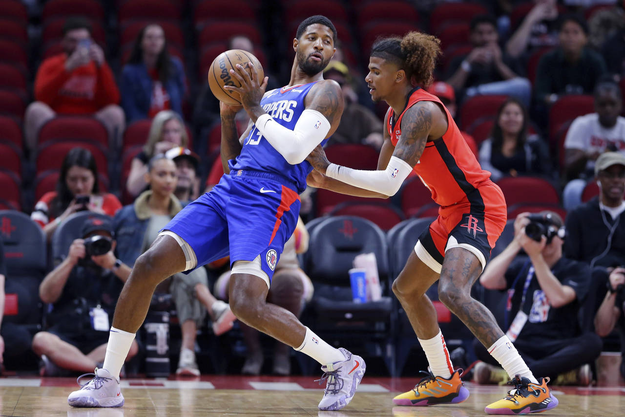 Los Angeles Clippers guard Paul George (13) leans back into Houston Rockets guard Jalen Green durin...