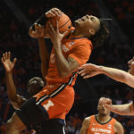 
              Illinois' Terrence Shannon Jr. (0) is fouled by Monmouth's Myles Ruth, left, as Jack Holmstrom, right, defends during the first half of an NCAA college basketball game, Monday, Nov. 14, 2022, in Champaign, Ill. (AP Photo/Michael Allio)
            