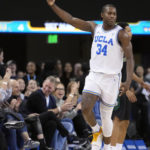 
              UCLA guard David Singleton (34) celebrates after making a three-point basket during the first half of an NCAA college basketball game against Sacramento State Monday, Nov. 7, 2022, in Los Angeles. (AP Photo/Marcio Jose Sanchez)
            