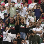 
              Iranian supporters react during the Iran's national anthem ahead the World Cup group B soccer match between England and Iran at the Khalifa International Stadium in in Doha, Qatar, Monday, Nov. 21, 2022. (AP Photo/Alessandra Tarantino)
            