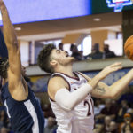 
              Virginia Tech's Grant Basile (21) goes up for a shot ahead of Penn State's Seth Lundy (1) in the second half of an NCAA college basketball game at the Charleston Classic in Charleston, S.C., Friday, Nov. 18, 2022. (AP Photo/Mic Smith)
            