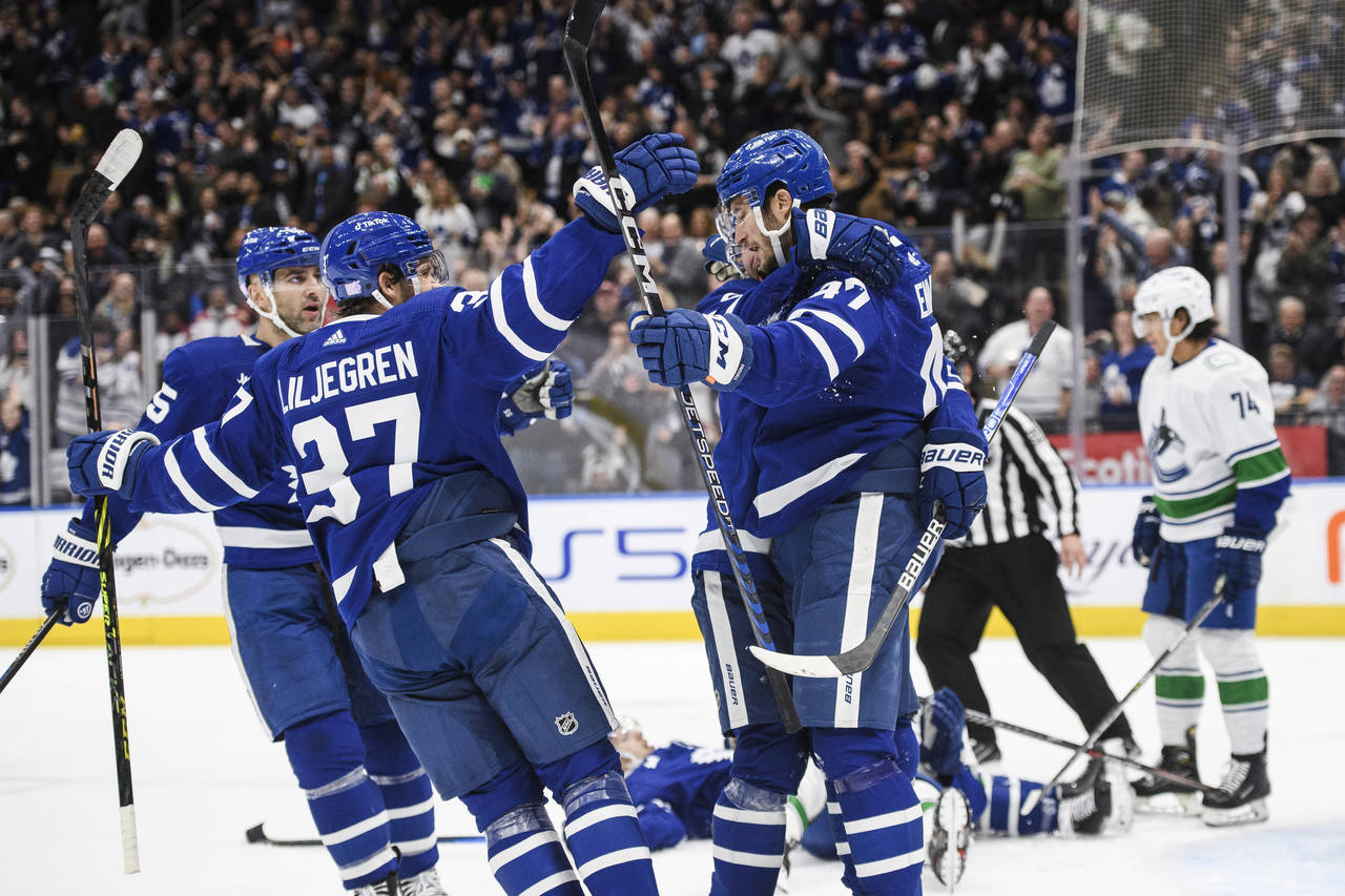 The Toronto Maple Leafs celebrate after left wing Pierre Engvall (47) scored against the Vancouver ...