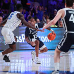 
              In a photo provided by Bahamas Visual Services, Butler's Jayden Taylor is defended by BYU's Gideon George as Butler's Simas Lukosius watches during an NCAA college basketball game in the Battle 4 Atlantis at Paradise Island, Bahamas, Thursday, Nov. 24, 2022. (Tim Aylen/Bahamas Visual Services via AP)
            