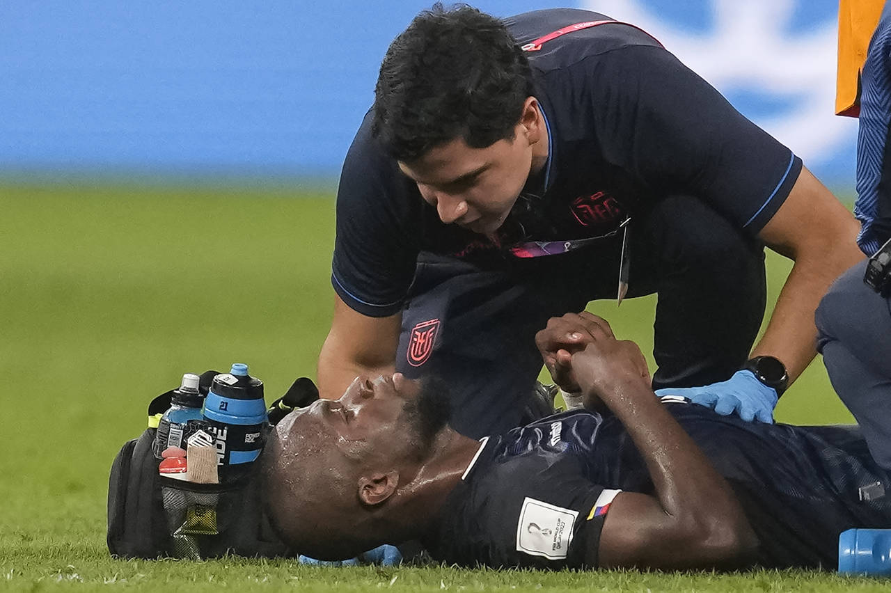 Ecuador's Enner Valencia is attended by medical personnel during the World Cup group A soccer match...