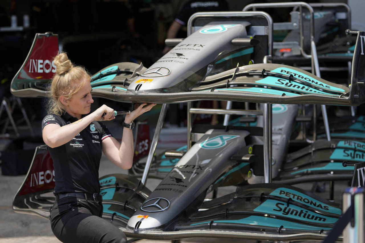 A member of Mercedes team crew works on the car of George Russell, of Britain, ahead of Sunday's Fo...