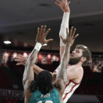 
              Oklahoma forward Tanner Groves, right, shoots in front of UNC Wilmington center Victor Enoh (12) in the second half of an NCAA college basketball game Tuesday, Nov. 15, 2022, in Norman, Okla. (AP Photo/Sue Ogrocki)
            