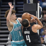 
              Orlando Magic guard Jalen Suggs (4) is fouled by Charlotte Hornets guard LaMelo Ball (1) while driving to the basket during the first half of an NBA basketball game, Monday, Nov. 14, 2022, in Orlando, Fla. (AP Photo/Phelan M. Ebenhack)
            