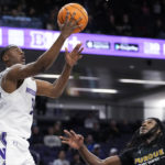 
              Northwestern guard Chase Audige, left, drives to the basket against Purdue Fort Wayne guard Deonte Billups during the second half of an NCAA college basketball game in Evanston, Ill., Friday, Nov. 18, 2022. (AP Photo/Nam Y. Huh)
            