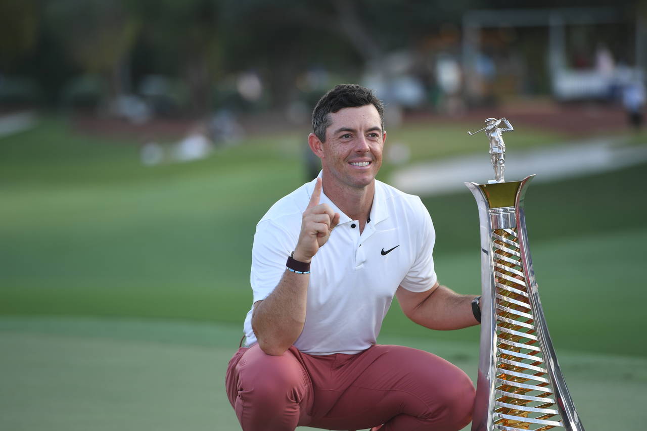 Rory McIlroy of Northern Ireland is posing with the trophy for his fourth win of the DP World Tour ...
