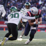 
              New England Patriots quarterback Mac Jones, right, is tackled by New York Jets cornerback Michael Carter II (30) during the first half of an NFL football game, Sunday, Nov. 20, 2022, in Foxborough, Mass. (AP Photo/Michael Dwyer)
            