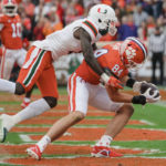 
              Clemson tight end Davis Allen (84) catches a pass for a touchdown while covered by Miami cornerback DJ Ivey in the first half of an NCAA college football game on Saturday, Nov. 19, 2022, in Clemson, S.C. (AP Photo/Jacob Kupferman)
            