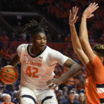 
              Illinois' Dain Dainja (42) works inside against Syracuse's Jesse Edwards during the first half of an NCAA college basketball game Tuesday, Nov. 29, 2022, in Champaign, Ill. Dainja was called for an offensive foul. (AP Photo/Michael Allio)
            