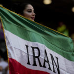 
              A soccer fan holds a flag from Iran prior to the World Cup group B soccer match between Wales and Iran, at the Ahmad Bin Ali Stadium in Al Rayyan , Qatar, Friday, Nov. 25, 2022. (AP Photo/Francisco Seco)
            