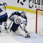
              Winnipeg Jets goaltender Connor Hellebuyck (37) watches the puck go in for a goal as Jets defenseman Josh Morrissey (44) works against Minnesota Wild center Connor Dewar (26) during the first period of an NHL hockey game Wednesday, Nov. 23, 2022, in St. Paul, Minn. (AP Photo/Andy Clayton-King)
            