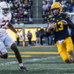 
              California quarterback Jack Plummer (13) runs with the ball as Stanford defensive end David Bailey (23) gives chase during the second quarter of an NCAA college football game in Berkeley, Calif., Saturday, Nov. 19, 2022. (Stephen Lam/San Francisco Chronicle via AP)
            