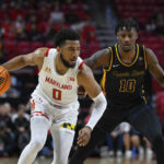 
              Maryland guard Don Carey (0) handles the ball against Coppin State guard Kam'Ron Blue (10) during the first half of an NCAA basketball game, Friday, Nov. 25, 2022, in College Park, Md. (AP Photo/Terrance Williams)
            