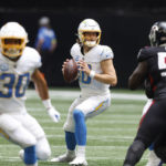 
              Los Angeles Chargers quarterback Justin Herbert (10) looks to pass during the first half of an NFL football game Atlanta Falcons, Tuesday, Dec. 6, 2022, in Atlanta. (AP Photo/Butch Dill)
            