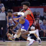 
              Los Angeles Clippers guard Paul George, left, has the ball knocked away by Houston Rockets guard Daishen Nix during the first half of an NBA basketball game Wednesday, Nov. 2, 2022, in Houston. (AP Photo/Michael Wyke)
            