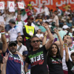 
              Iranian soccer fans shout slogan "Woman Life Freedom" prior to the World Cup group B soccer match between England and Iran at the Khalifa International Stadium in in Doha, Qatar, Monday, Nov. 21, 2022. (AP Photo/Alessandra Tarantino)
            