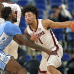 
              North Carolina forward Leaky Black, left, defends against Alabama guard Mark Sears (1) during the first half of an NCAA college basketball game in the Phil Knight Invitational on Sunday, Nov. 27, 2022, in Portland, Ore. (AP Photo/Rick Bowmer)
            
