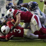 
              Seattle Seahawks running back Kenneth Walker III, left, scores a touchdown against the Arizona Cardinals during the second half of an NFL football game, Sunday, Nov. 6, 2022, in Glendale, Ariz. (AP Photo/Matt York)
            