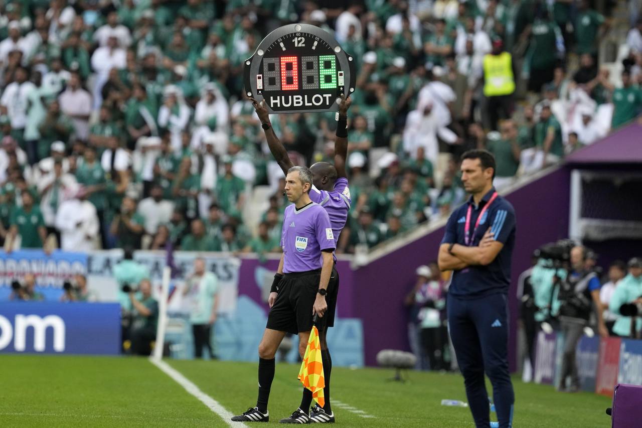 The referee assistant shows 8 minutes overtime during the World Cup group C soccer match between Ar...